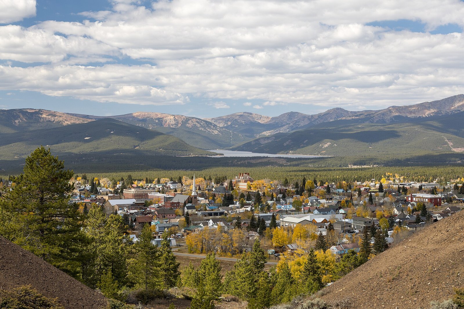The town of Leadville with yellow aspens and cottonwoods among its streets, Turquoise Lake and wide mountains beyond.
